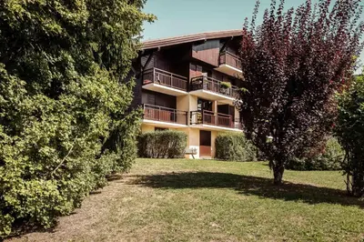 an apartment building with a tree in front of it at Flat Sofia - Authentic charm in Demi-Quartier
