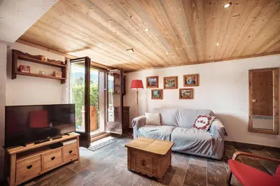 a living room with a couch and a flat screen tv at Flat Sofia - Authentic charm in Demi-Quartier
