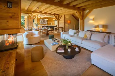 a living room with white furniture and a fireplace at Chalet Piccolo - OVO Network in Saint-Gervais-les-Bains