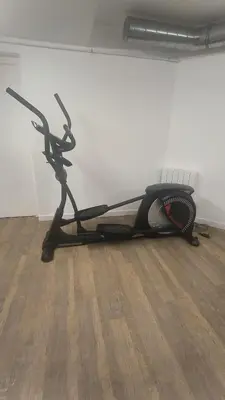 a exercise bike sitting on the floor in a room at Appartement ludothèque familial neuf à Combloux in Combloux