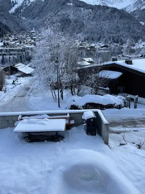 a yard covered in snow next to a road at Chalet Cristal I in Les Contamines-Montjoie