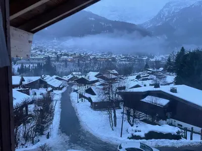 a village covered in snow with mountains in the background at Chalet Cristal I in Les Contamines-Montjoie