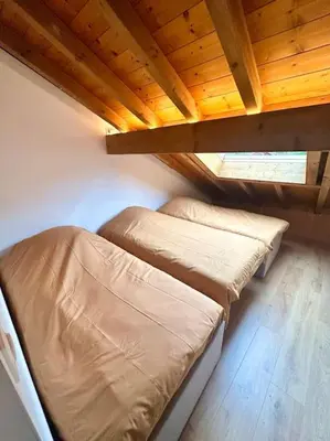a kitchen with white cabinets and a sink and a stove at Le tilleul-cœur du village in Samoëns