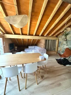 a living room with a flat screen tv and a couch at Le tilleul-cœur du village in Samoëns