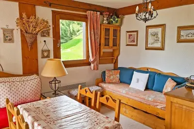 a living room with a couch and a table at Exceptional view of village and mountain in Megève
