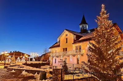 a christmas tree is in front of a building at Exceptional view of village and mountain in Megève