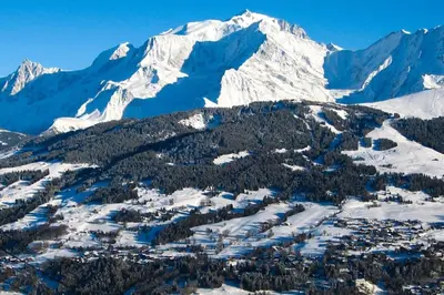 an aerial view of a ski resort in front of a snow covered mountain at Exceptional view of village and mountain in Megève