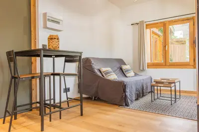 a living room with a couch and a table at Studio Miloé secteur TMB in Saint-Gervais-les-Bains