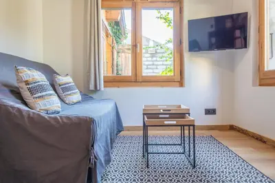 a living room with a couch and a table at Studio Miloé secteur TMB in Saint-Gervais-les-Bains