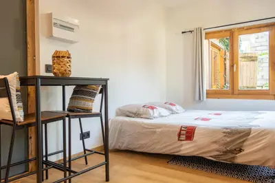 a bedroom with a bed and a window at Studio Miloé secteur TMB in Saint-Gervais-les-Bains