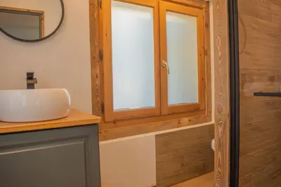 a bathroom with a sink and a mirror at Studio Miloé secteur TMB in Saint-Gervais-les-Bains