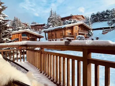 a snow covered mountain range with clouds in the foreground at Magnifique appartement au coeur de Megève in Megève