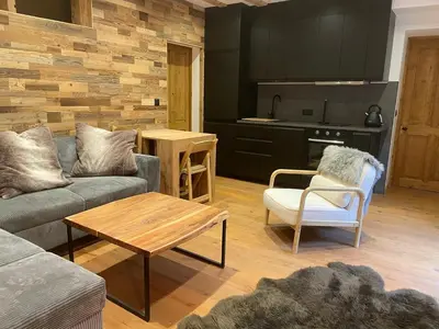a couch with a fur blanket on top of it at Chalet OurSouris in Saint-Gervais-les-Bains