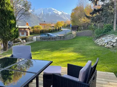 a backyard with a house and a fence at Chalet OurSouris in Saint-Gervais-les-Bains