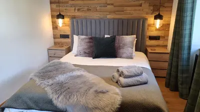 a bedroom with a bed with pillows and a radiator at Chalet OurSouris in Saint-Gervais-les-Bains