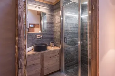 a bathroom with a sink and a shower at Appartement de Charvin - Welkeys in Megève