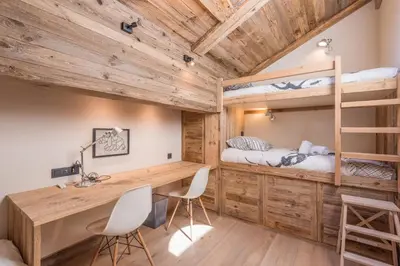 a bedroom with a desk and bunk beds at Appartement de Charvin - Welkeys in Megève