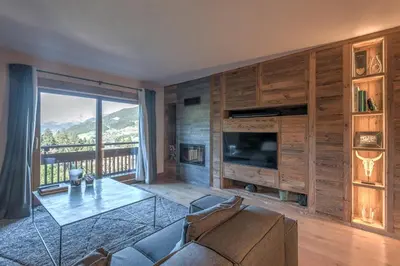 a living room with a couch and a glass table at Appartement de Charvin - Welkeys in Megève