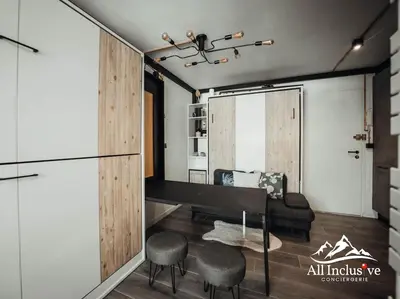 a living room with a couch and a table and chairs at Charmant Studio - Moderne - Proche centre in Megève