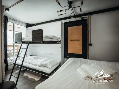 a room with a bunk bed and a ladder at Charmant Studio - Moderne - Proche centre in Megève