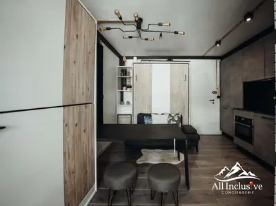 a living room with a dining room table and chairs at Charmant Studio - Moderne - Proche centre in Megève