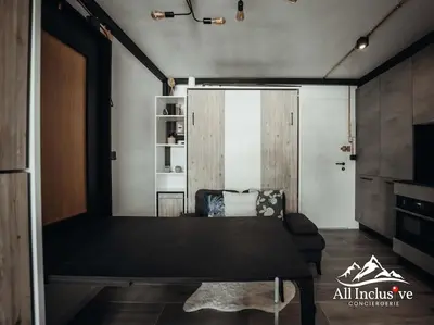 a room with a bed and a couch in a room at Charmant Studio - Moderne - Proche centre in Megève