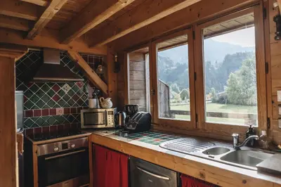 a kitchen with a sink and a window in a cabin at La table de Fifine - Montagne - Appartement 65m2 in Samoëns