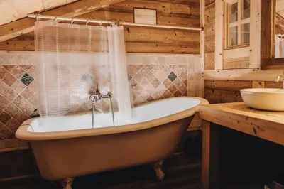a bathroom with a tub and a sink at La table de Fifine - Montagne - Appartement 65m2 in Samoëns