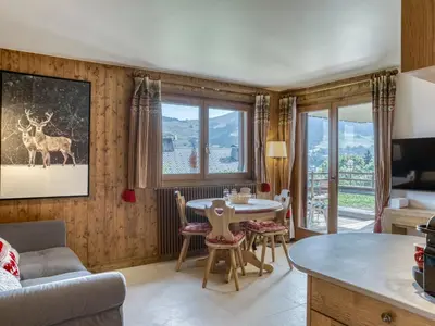 a kitchen and living room with a table and chairs at Appartement cosy avec terrasse à Megève, idéal pour 2 à 3 personnes - FR-1-453-317 in Megève