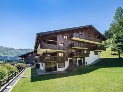 a large building with balconies on the side of it at Appartement cosy avec terrasse à Megève, idéal pour 2 à 3 personnes - FR-1-453-317 in Megève
