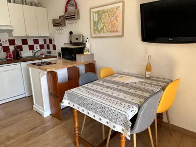 a kitchen with a table with a table cloth on it at Les Cîmes des Carroz in Les Carroz d'Araches