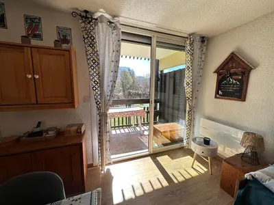 a room with a sliding glass door to a balcony at Les Cîmes des Carroz in Les Carroz d'Araches