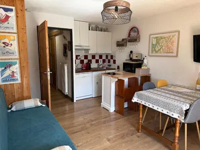 a kitchen and dining room with a table in a room at Les Cîmes des Carroz in Les Carroz d'Araches