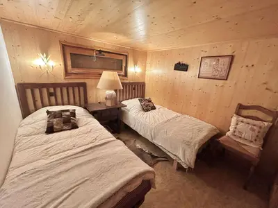 a bedroom with two beds and a table with a lamp at Chalet 6-8 pers, 4 chambres, proche remontées, parking - FR-1-597-182 in Megève