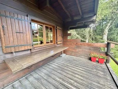 a porch of a wooden cabin with two potted plants at Chalet 6-8 pers, 4 chambres, proche remontées, parking - FR-1-597-182 in Megève
