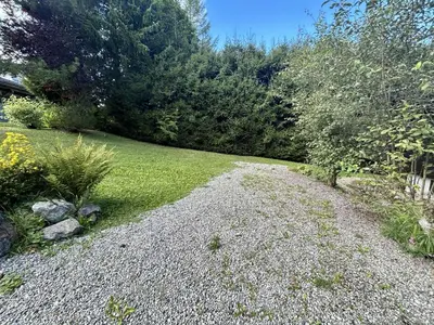a gravel path in a yard with trees and grass at Chalet 6-8 pers, 4 chambres, proche remontées, parking - FR-1-597-182 in Megève