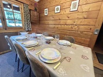 a dining room table with plates and glasses on it at Chalet 6-8 pers, 4 chambres, proche remontées, parking - FR-1-597-182 in Megève