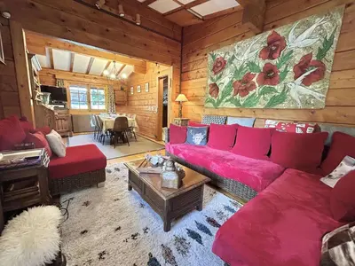a living room with a red couch and a table at Chalet 6-8 pers, 4 chambres, proche remontées, parking - FR-1-597-182 in Megève