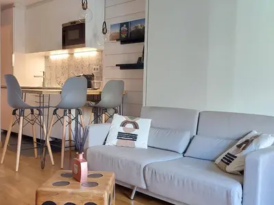 a living room with a couch and a table at Studio confortable rénové en résidence verdoyante à Chamonix - FR-1-517-69 in Chamonix-Mont-Blanc