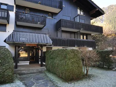 a building with balconies and bushes in front of it at Studio confortable rénové en résidence verdoyante à Chamonix - FR-1-517-69 in Chamonix-Mont-Blanc