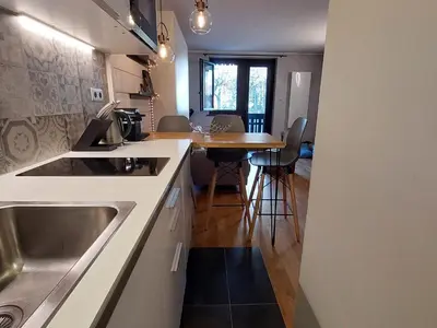 a kitchen with a sink and a wooden table at Studio confortable rénové en résidence verdoyante à Chamonix - FR-1-517-69 in Chamonix-Mont-Blanc