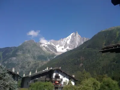 a snow covered mountain with a building in the foreground at Studio confortable rénové en résidence verdoyante à Chamonix - FR-1-517-69 in Chamonix-Mont-Blanc