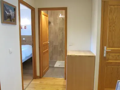 a bathroom with a shower and a door to a bedroom at Evasion Sérénité à Chamonix Mont-Blanc in Chamonix-Mont-Blanc