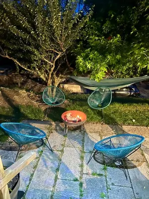 a group of chairs and a table and a boat at Chalet les vergers in Sallanches