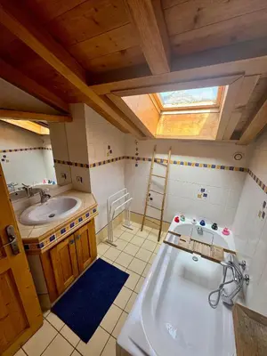 a bathroom with a large tub and a sink at Chalet les vergers in Sallanches