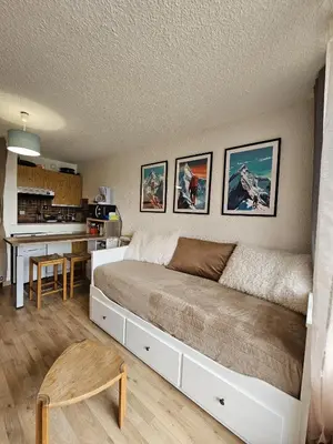 a bedroom with a large bed and a table at studio plein SUD été comme hiver in Les Carroz d'Araches
