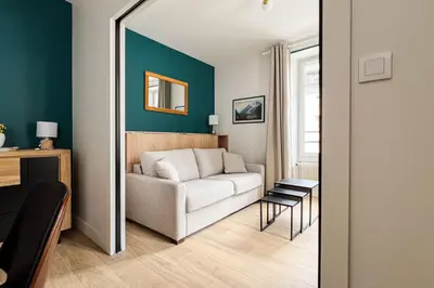 a living room with a couch and a chair at Spacious T2 in the heart of Chamonix in Chamonix-Mont-Blanc
