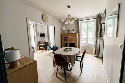 a living room with a white couch and a mirror at Spacious T2 in the heart of Chamonix in Chamonix-Mont-Blanc