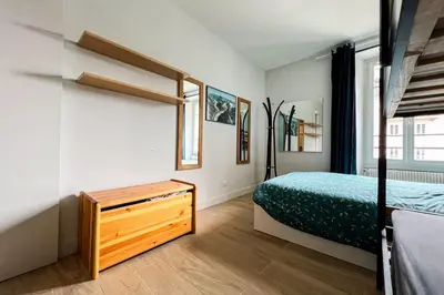 a bedroom with two bunk beds and a window at Spacious T2 in the heart of Chamonix in Chamonix-Mont-Blanc