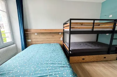 a bedroom with a bed and a dresser in it at Spacious T2 in the heart of Chamonix in Chamonix-Mont-Blanc